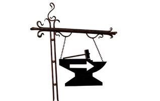 Iron hanging pointer, right arrow, anvil and hammer isolated on white background. in the old Slavic style photo