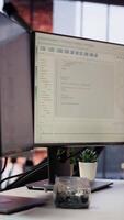 Vertical Advanced AI algorithms running on computer monitors in empty startup workspace deploying machine learning models. Coding platform on PC screens in Silicon Valley office, close up shot video