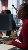 Vertical Software engineer solving tasks with AI LLM chatbot answering prompts using predictive technology. Startup staff member using computer to interact with generative large language model app, camera A video