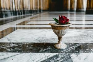 Single red rose in a marble vase on a marble floor photo