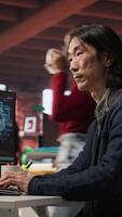 Vertical CTO manager in AI startup drinking coffee while coding applications in programming languages. Chief technician officer enjoying hot beverage while doing code testing and quality assurance, camera A video