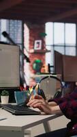 Vertical Startup cybersecurity expert looking for company security vulnerabilities on computer monitors. Software development agency programmer installing fortified code on PC, camera A video