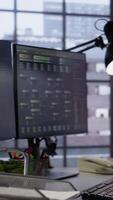 Vertical PC screens in innovative startup office showing programming languages used to build applications. Empty software development agency used for optimizing code on computers, handheld camera shot video