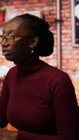 Vertical Programmer coding artificial intelligence algorithm in startup, refining machine learning models to enhance automation and data driven decision making. Woman using coding platform in office, camera B video