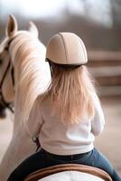 Children learn to ride well-groomed horses in a tranquil stable setting, illuminated by soft natural light and surrounded by beautiful blurred countryside. The atmosphere is calm and exclusive photo