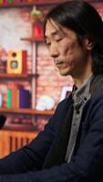 Vertical AI startup office chief technology officer drinking coffee and building application. Senior manager enjoying hot beverage while working in artificial intelligence software development agency, camera B video