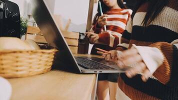 Two women are using a laptop on a table video