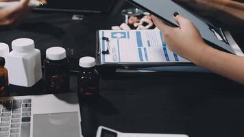 A person is sitting at a desk with a laptop and a clipboard video