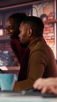Vertical Startup staff members gathered together to conduct code review to fix bugs, identifying technical issues. Artificial intelligence company coworkers doing brainstorming, optimizing code, camera B video