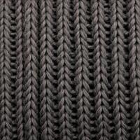 Texture of smooth knitted dark sweater with pattern. Top view, close-up. Handmade knitting wool or cotton fabric texture. Background of knitting patterns with a vertical large Braid Cable. photo