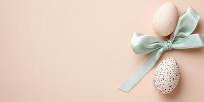 Decorative easter eggs with blue ribbon on minimal beige background photo