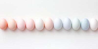Pastel-colored eggs arranged in a row against a light background photo