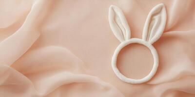 Delicate bunny ears headband on soft fabric background, perfect for easter themes photo
