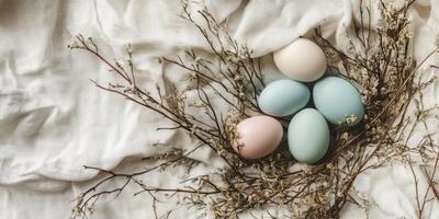 Pastel easter eggs with delicate branches on soft fabric background photo