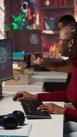 Vertical Programmer coding artificial intelligence algorithm in startup, refining machine learning models to enhance automation and data driven decision making. Woman using coding platform in office, camera A video