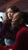 Vertical Teamworking engineers coding advanced AI algorithm and machine learning models enhancing automation. Employee talking with coworker in artificial intelligence Silicon Valley workspace, camera A video