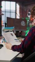 Vertical Tech startup HR employee analyzing candidates for job opening, reviewing resumes to determine skills. Woman screening people for software development Silicon Valley company position, camera A video