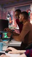 Vertical Startup staff members gathered together to conduct code review to fix bugs, identifying technical issues. Artificial intelligence company coworkers doing brainstorming, optimizing code, camera A video