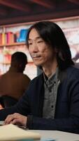 Vertical Startup manager leveraging machine learning technology in office to gain competitive edge. Asian Silicon Valley company IT expert working on rapid technological advancement, camera A video