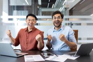 Office workers celebrate success in modern workspace, expressing joy and enthusiasm. Colleagues display teamwork, achievement, and motivation, contributing to positive work environment and corporate photo