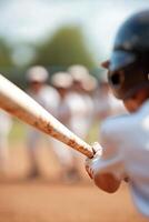 A child confidently swings a baseball bat while teammates cheer enthusiastically from a blurred crowd in the background on a sunny day at the baseball field photo