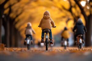 A group of children rides bikes along a charming tree-lined path, basking in the soft sunlight filtering through vibrant autumn leaves, embodying a sense of freedom and joy photo