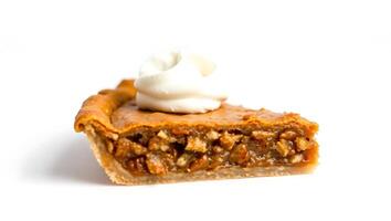 Slice of pecan pie with whipped cream topping on a simple plate photo