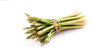 Fresh bunch of asparagus tied with twine on a simple surface photo