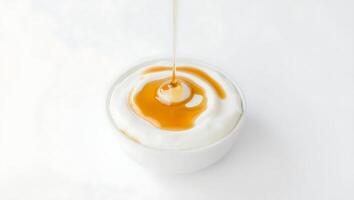 Creamy yogurt with honey drizzle on a clean surface photo