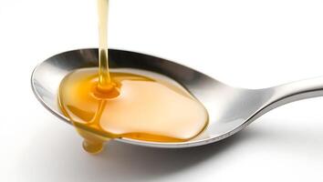 Spoon dripping honey with glossy texture next to shiny silver utensil photo
