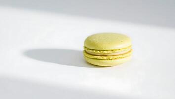 Green macaron on a white surface with soft shadow photo