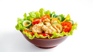 Fresh salad bowl with mixed vegetables and chicken bites photo