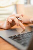 Close-up image of hands typing on a laptop keyboard, highlighting modern technology and productivity in a workspace. photo