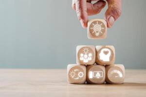 Wooden blocks with icons representing design thinking concepts, showcasing innovation and creative problem-solving strategies. photo