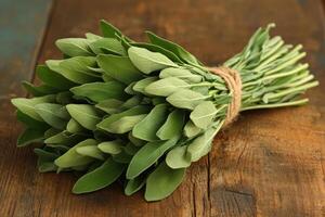 Fresh sage bundle on rustic wooden table photo