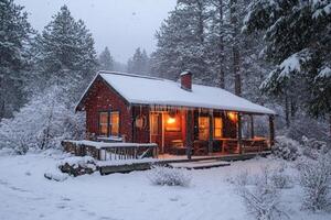 Cozy red wooden cabin covered in snow during a winter snowfall photo