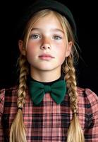 Portrait of a young girl with freckles wearing a bow tie and hat photo