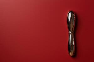 Elegant gold butter knife on a red background photo