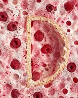 Raspberry dessert with a slice of cake surrounded by foam photo