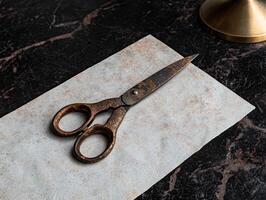 Vintage ornate scissors on a textured surface photo