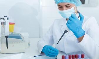 Young lab assistant collecting blood samples from big pipette for testing, copy space, panorama photo