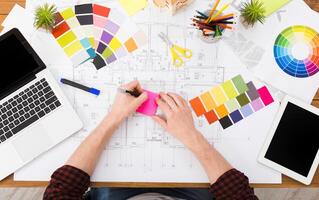 Interior designer working with color palette top view. Architect choosing colors for building decoration, blank tablet and laptop screen, mockup photo