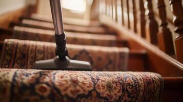 A person is vacuuming a patterned carpet on the stairs as part of a spring cleaning routine. The warm sunlight filters through a nearby window, creating a bright and inviting atmosphere. photo