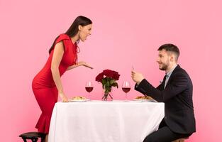 Jealousy. Indifferent Boyfriend Using Phone Ignoring Girlfriend Shouting At Him During Date Over Yellow Studio Background. photo