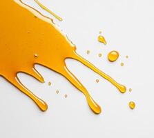 Thick and golden honey flows and splashes across a smooth white surface, creating a delightful mess. The liquid glistens in the light, showcasing its rich texture and sweetness. photo