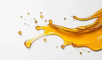 Golden honey splashes across a clean surface, creating intricate patterns and droplets. photo
