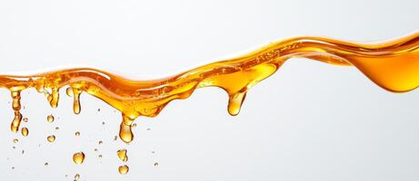 Golden honey flows gracefully, forming splashes and droplets in mid-air. The vibrant liquid contrasts strikingly with the plain backdrop, highlighting its texture and movement. photo