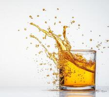 Liquid honey splashes dramatically from a clear glass, creating beautiful droplets against a bright background. The moment captures the essence of movement and sweetness in an artistic display. photo