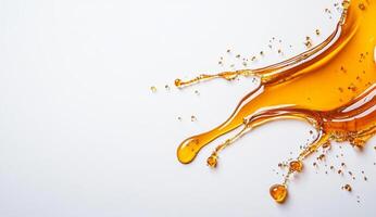 Golden honey splashes against a white background, showcasing a liquid flow. Droplets emerge from the main splash, creating an artistic display of texture and color that highlights its viscosity. photo