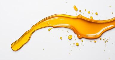Golden honey flows and splashes across a smooth white surface, showcasing its thick, viscous texture and vibrant color. The dynamic shapes formed add a touch of beauty to this natural substance. photo